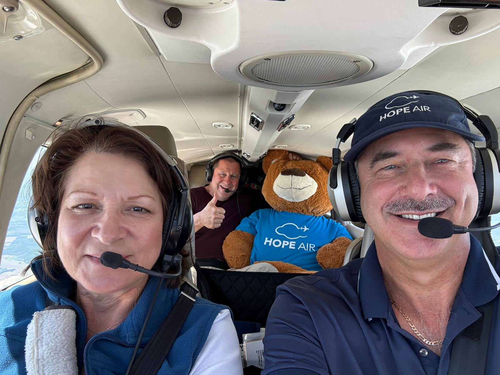 Ed and Debbie Johnston en route to Charlottetown, with Kirk Passmore and the Hope Air Jet Bear.