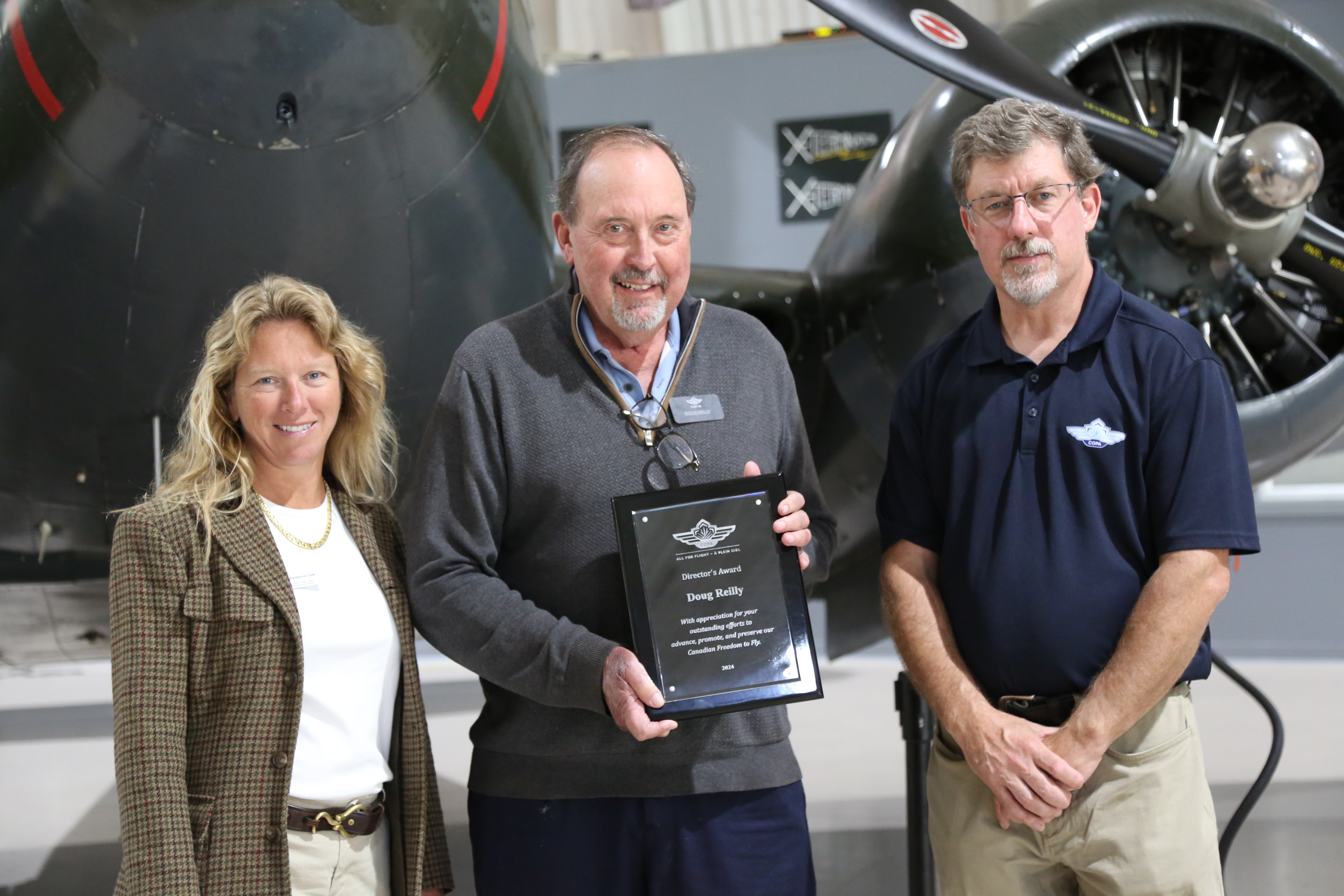 Doug Reilly (center), recipient of the Directors' Award at the 2024 AGM.