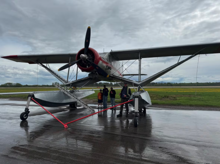 Pilot Glenn Pearce with some curious onlookers shows off the Bellanca Aircruiser, a float plane built in 1938, at the Vanderhoof, B.C. airport. Photo credit: Catherine Hansen/CBC