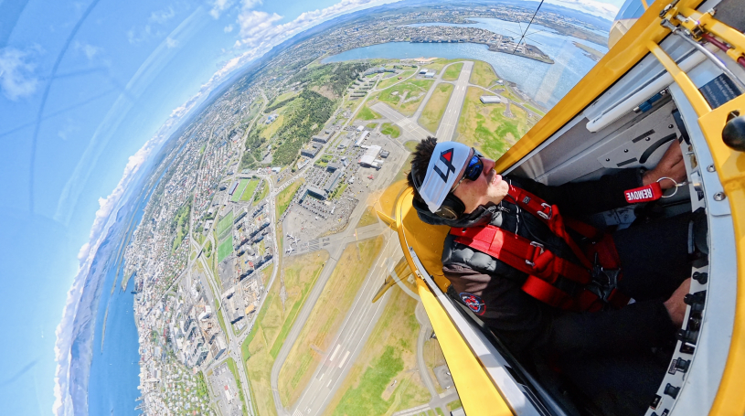 Fisheye photo of Luke Penner in the cockpit flying