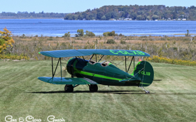 Photo of an airplane on a grass airstrip overlooking Lake Scugog.