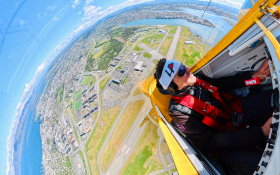 Fisheye photo of Luke Penner in the cockpit flying